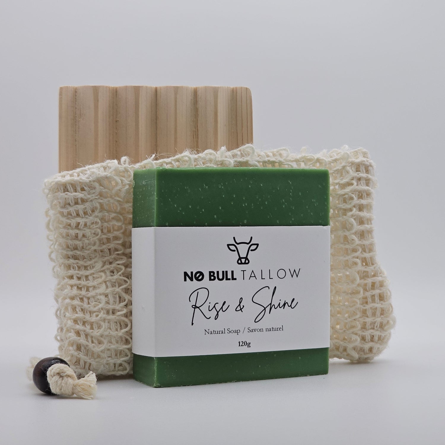 Natural tallow soap bar on top of a cedar soap dish and hemp soap saver