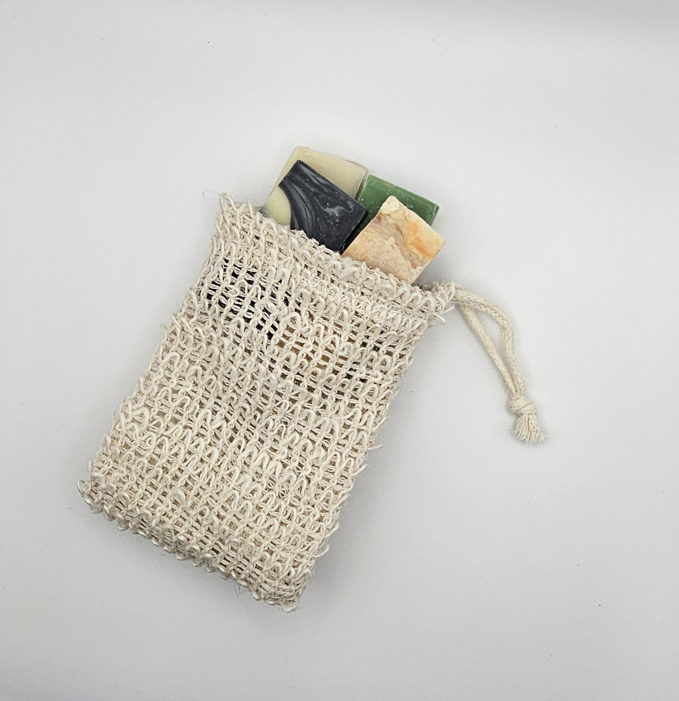 Mesh bag with soap bars on a light gray background