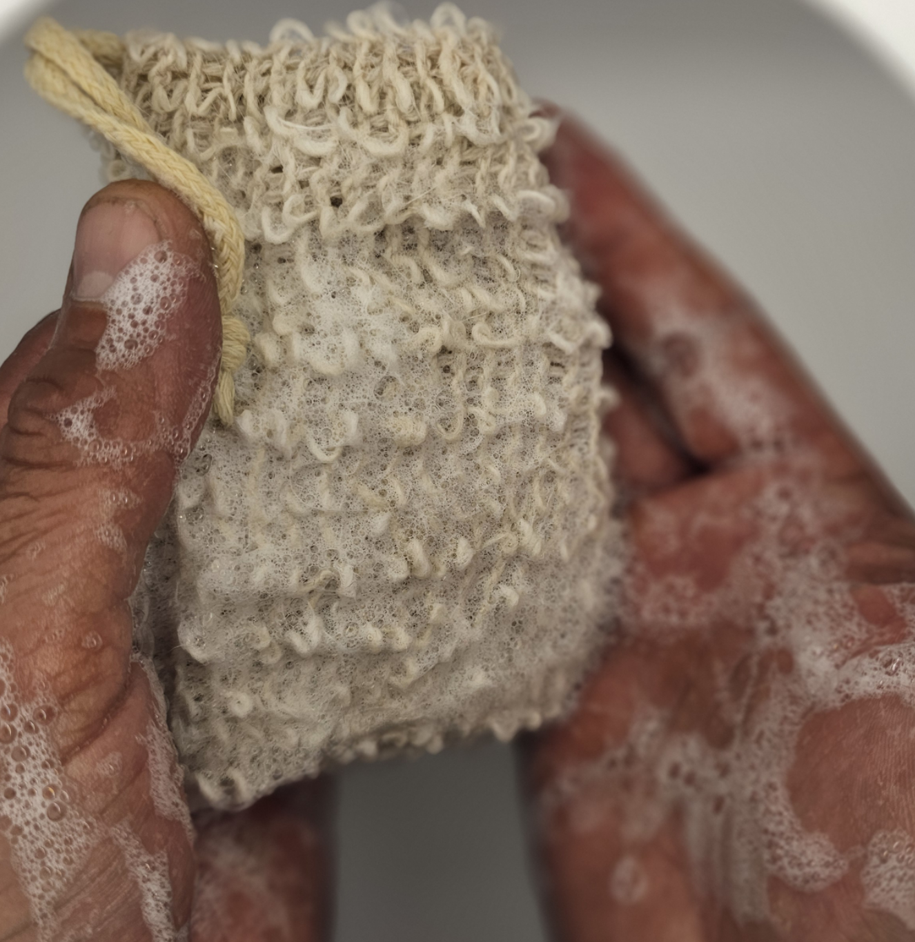 Reusable hemp soap saver bag filled with tallow soap – rich creamy lather and gentle exfoliation in use