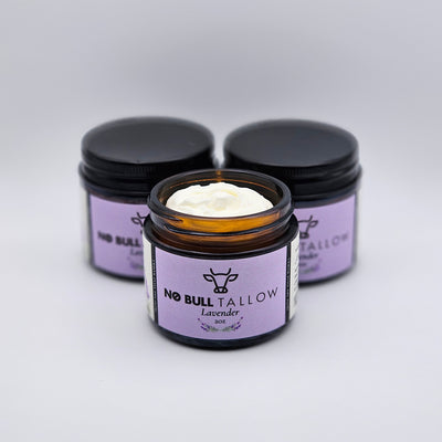 Three purple jars with of lavender body butter on a white background