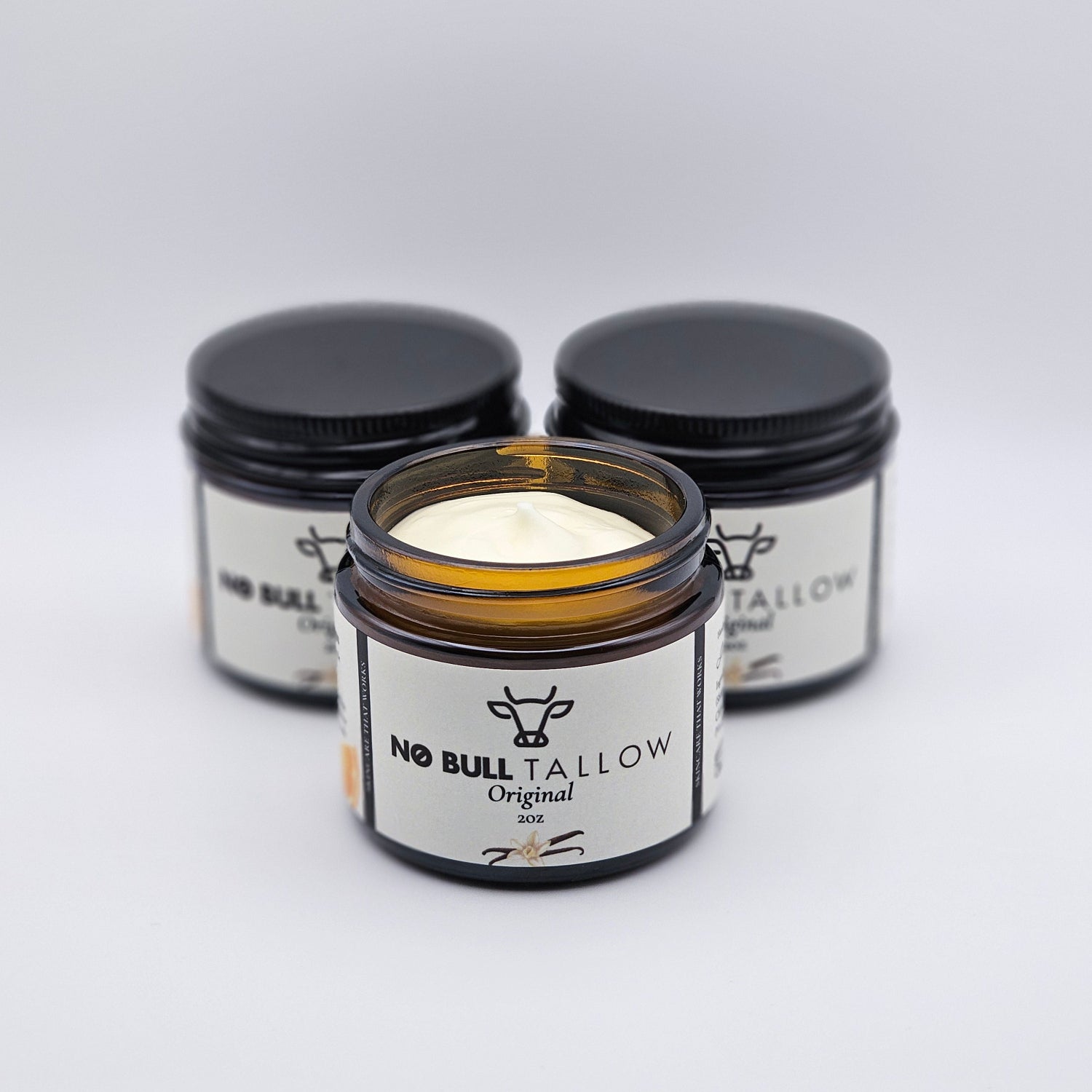 Three jars of No Bull Tollow Original Body Butter on a white background