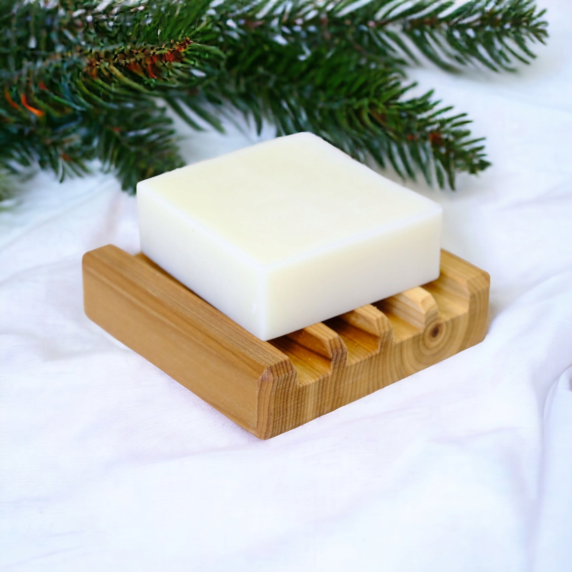 white soap bar on wood dish on fabric