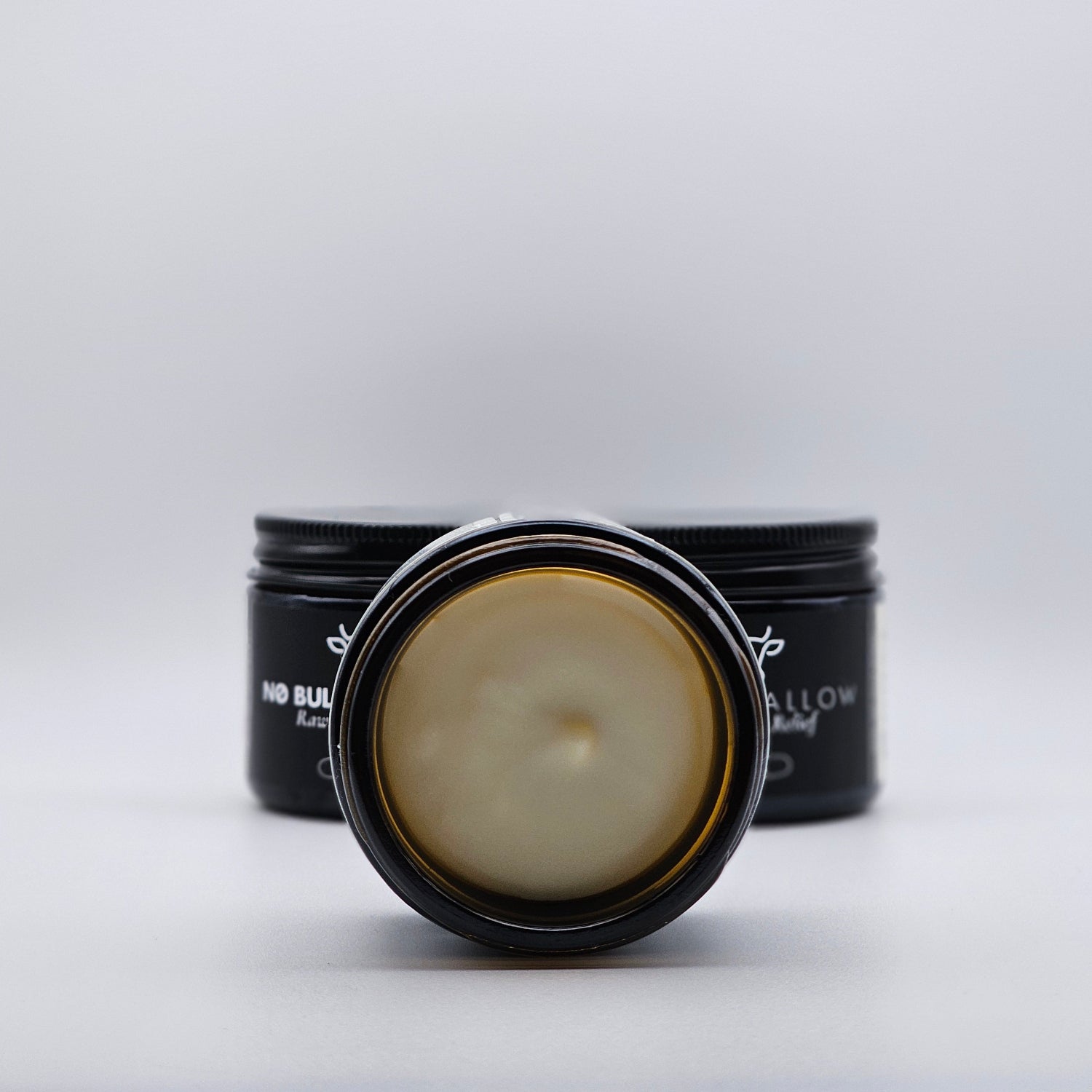 Trio of raw hide relief tallow body butter showing texture