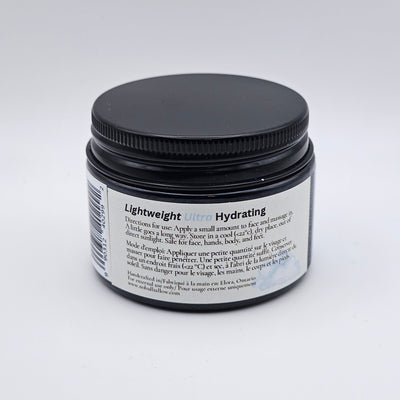 Cosmetic jar with black lid and white label on a light gray background