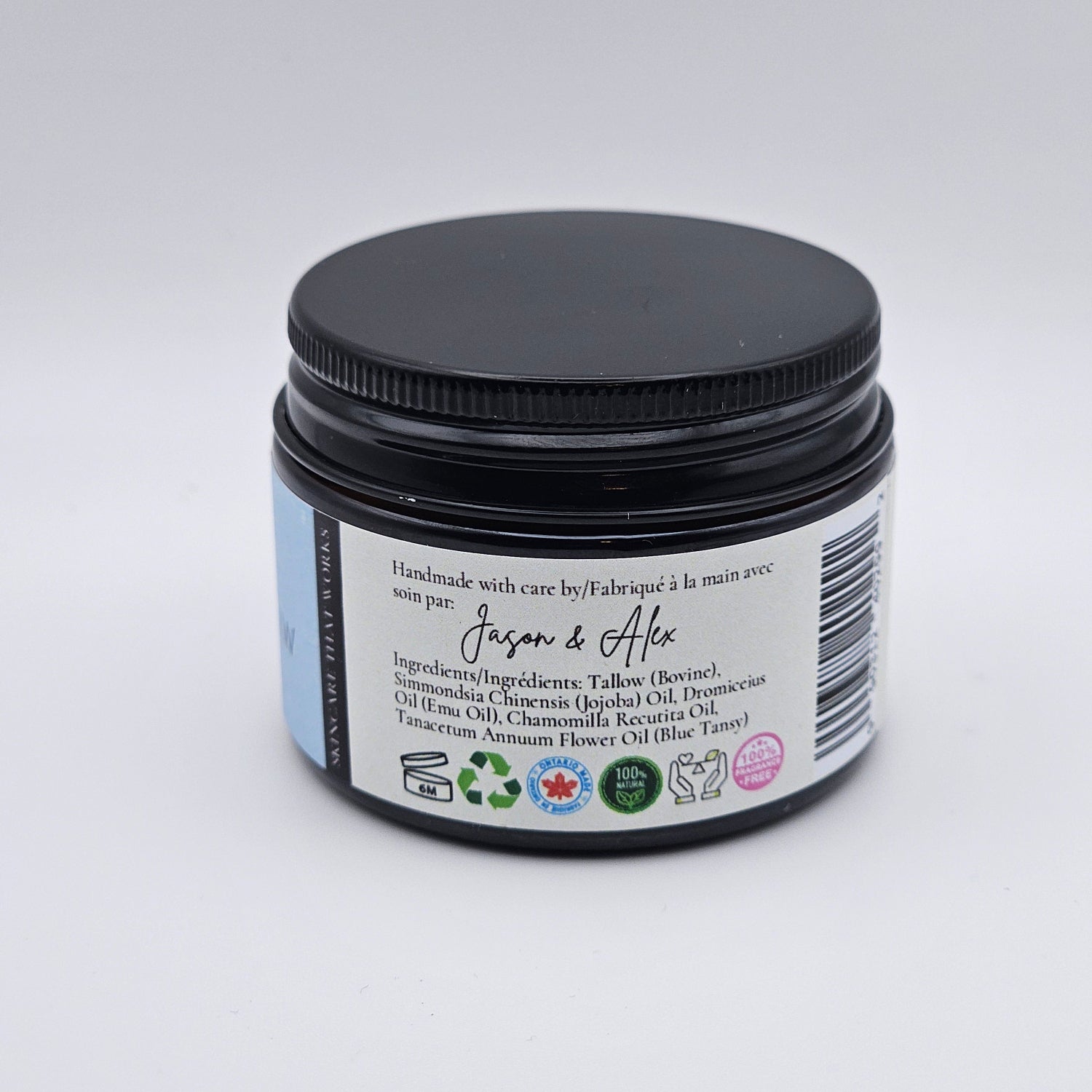 Jar of tallow face cream with a label on a white background