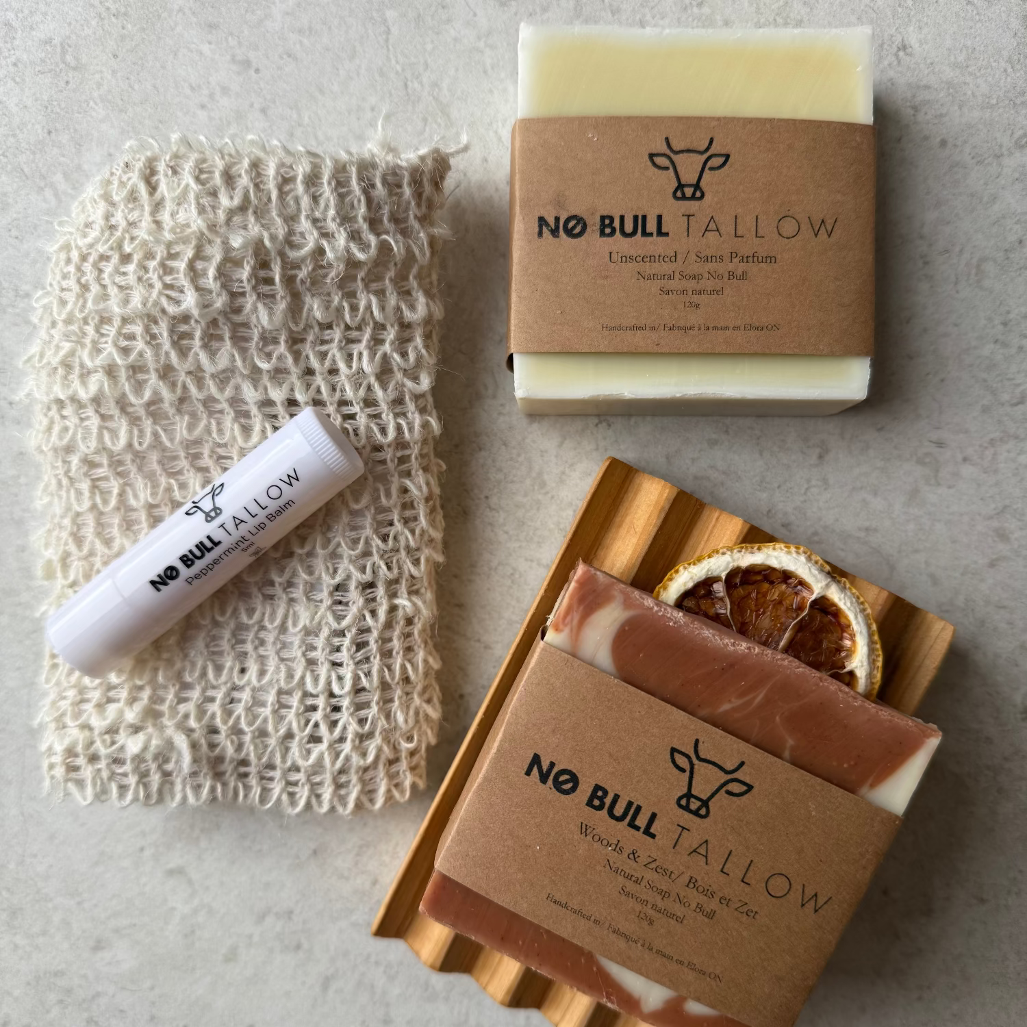 Natural skincare bundle with tallow soaps, cedar soap tray, lip balm, and reusable hemp soap saver bag