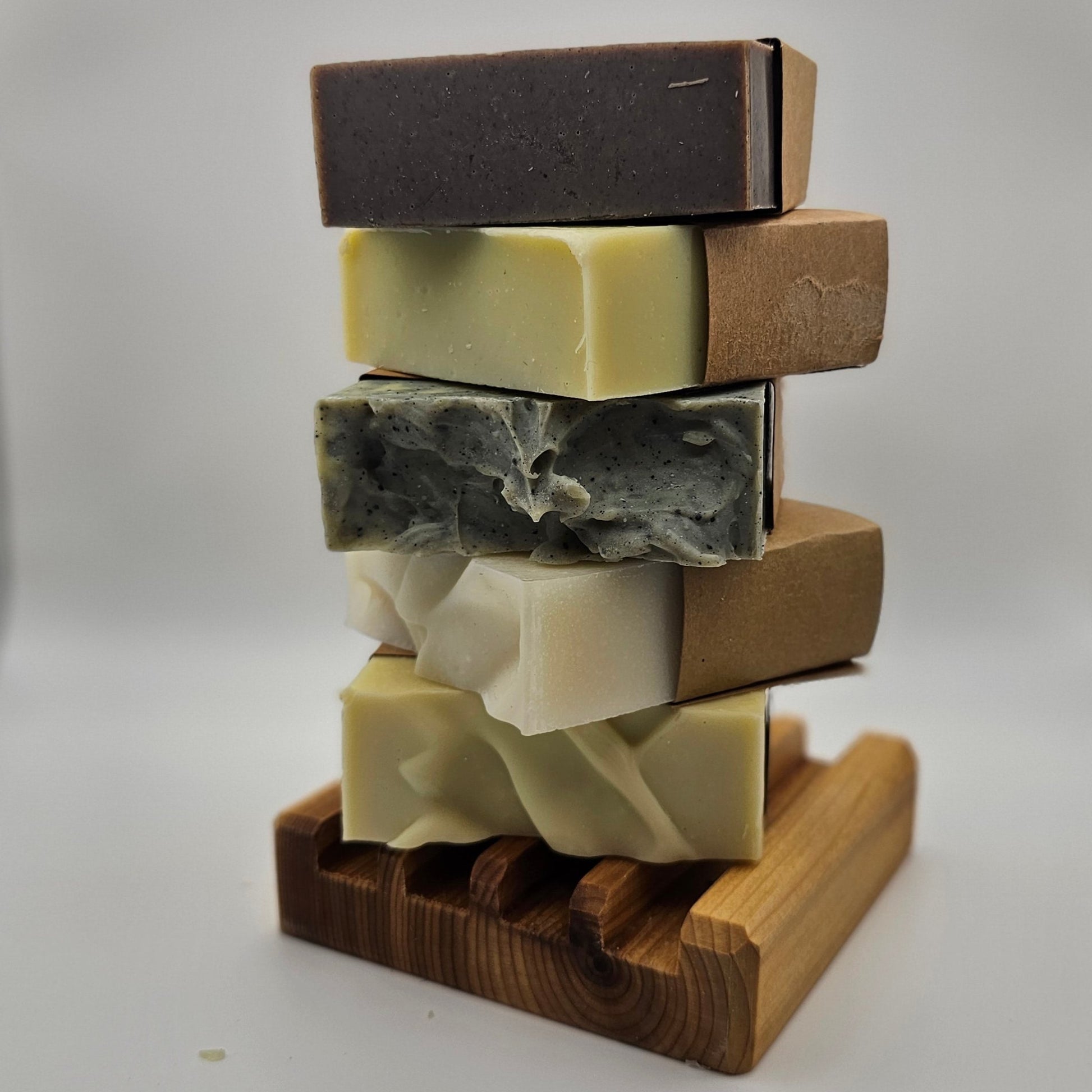 4 natural tallow soaps towered on a cedar soap dish