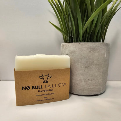 Natural tallow shampoo bar beside green plant on bathroom counter – eco-friendly solid shampoo for scalp balance